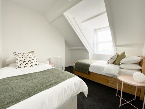 a bedroom with two beds and a window at 89 St John's Road Terrace House in Newcastle upon Tyne