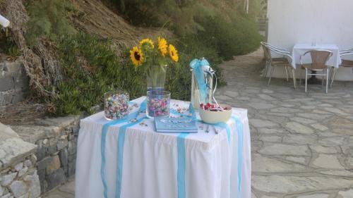 a table with a vase with flowers on it at Istron Bay Hotel in Istron
