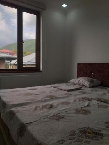 a bedroom with a large bed with a window at Orkide in Sheki