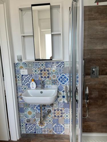 a bathroom with a sink and a mirror at B&B Sapore di Mare san salvo Marina in San Salvo