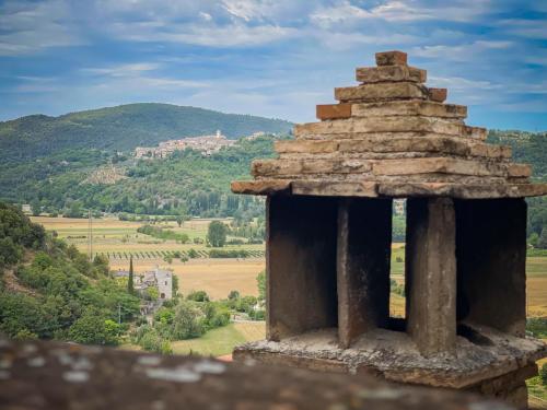 a stone tower with a view of a mountain at Borgo San Valentino in Arrone