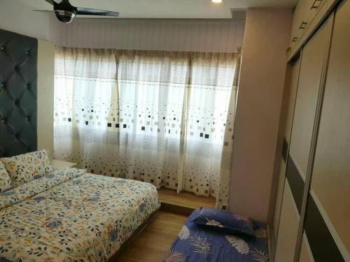 a small bedroom with a bed and a window at Best Sekinchan homestay in Sekinchan