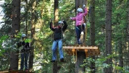 two people standing on a platform in a forest at Chata pod Kyčerou Zuberec Orava in Zuberec