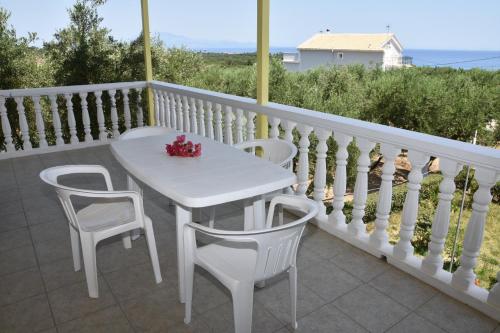 a white table and two chairs on a balcony at Casa Dyonisia Tsilivi in Plános
