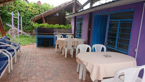 a group of tables and chairs on a patio at La casa de naty by Ecuapolsky in Tonsupa