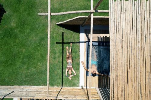 two people are jumping into a swimming pool at La Mer Resort Spa Crete in Georgioupolis