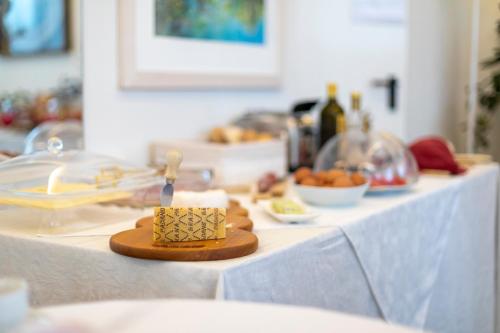 a table with a white table cloth with food on it at Hotel La Nuova Rotaia in Gallarate