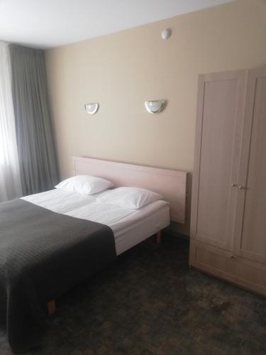 Ένα ή περισσότερα κρεβάτια σε δωμάτιο στο Hotel Senas Namas