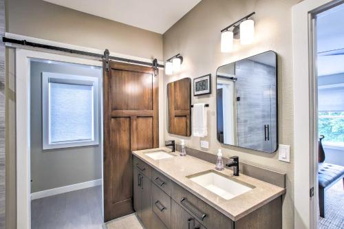 a bathroom with two sinks and a mirror at Chic Plymouth Townhome Less Than 1 Mi to Road America in Plymouth