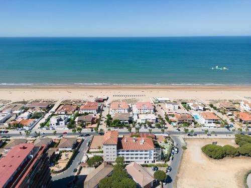 an aerial view of a city and the beach at Pato Rojo in Punta Umbría