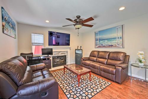 a living room with leather furniture and a fireplace at Karaoke Fun, Hot Tub and Patio! San Diego Sanctuary in San Diego