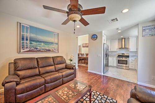 a living room with a couch and a ceiling fan at Karaoke Fun, Hot Tub and Patio! San Diego Sanctuary in San Diego