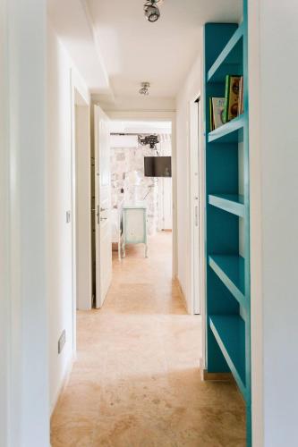 a hallway with blue shelves in a white room at Luxury 6 bedroom house on waterfront in Perast