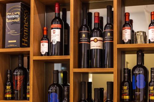 a bunch of bottles of wine on shelves at Grand Lakes Rooms in Plitvička Jezera