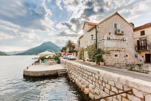 a group of buildings next to a body of water at Luxury 6 bedroom house on waterfront in Perast