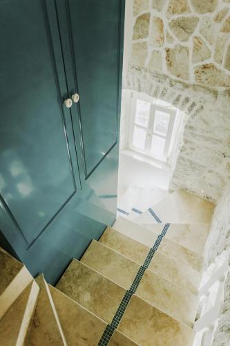 a bathroom with a walk in shower and a glass door at Luxury 6 bedroom house on waterfront in Perast