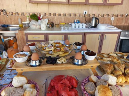 a table with a bunch of bread and pastries at Guest House Vera in Ulcinj