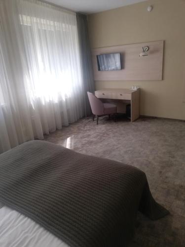 Ένα ή περισσότερα κρεβάτια σε δωμάτιο στο Hotel Senas Namas