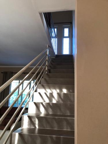 a staircase in a building with a window at Sunnyside Villa in Durrës