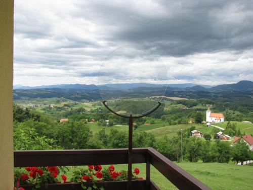 a hoop on a balcony with a view of a valley at Holiday House PANORAMA in Podčetrtek