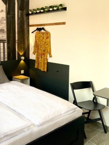 a bedroom with a bed and a chair at Dock 6 - Cuxhaven in Cuxhaven