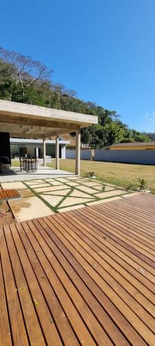 a wooden deck with a pavilion in a park at Casa Deck videiras in Rio de Janeiro