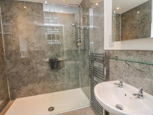 a bathroom with a sink and a shower at Larch in Newtonmore