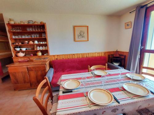 a table with plates on it in a room at Appartement Samoëns, 2 pièces, 7 personnes - FR-1-624-15 in Samoëns
