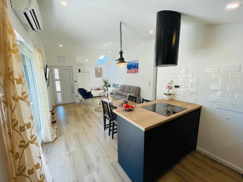 a kitchen and living room with a counter and a table at Apartman Ivana in Split