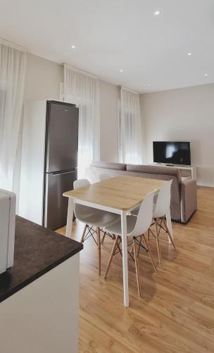 a kitchen and living room with a table and chairs at Apartamentos MIRADOR DEL TRANSITO in Toledo