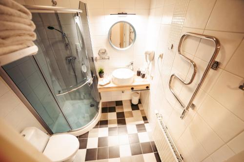 a bathroom with a shower and a toilet and a sink at Usma SPA Hotel & Camping in Usma