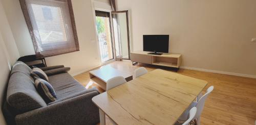 a living room with a couch and a table at Apartamentos MIRADOR DEL TRANSITO in Toledo