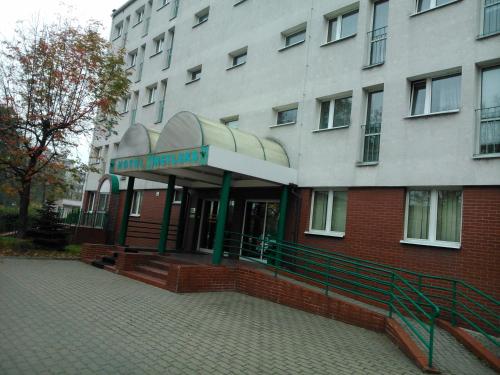 a building with a sign that reads new hospital at Hostel Refleks in Toruń