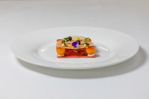 a white plate with a piece of food on it at Baglioni Hotel Luna - The Leading Hotels of the World in Venice