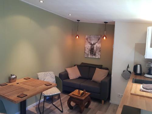 a living room with a couch and a table at Sleep Well Ness Domburg in Domburg