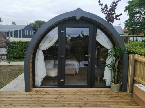 a gazebo with a door open on a patio at Luxury Glamping with lake & Mountain View in Culky
