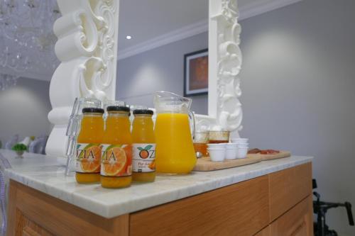 a group of bottles of orange juice on a counter at Hôtel Le Golfe Ecolabel EU in Porto Ota