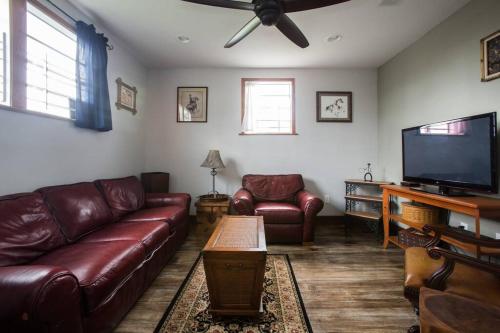 紐奧良的住宿－Big Easy Charmer License #23-OSTR-12410，客厅配有真皮沙发和平面电视