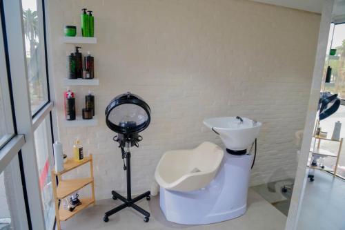 a bathroom with a sink and a mirror and a camera at Novotel Mohammedia in Mohammedia