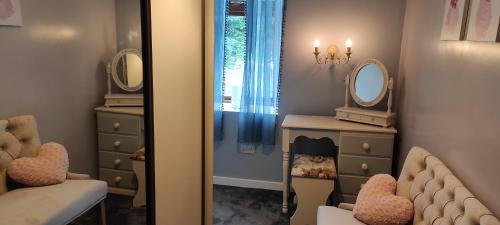 a dressing room with a mirror and a dresser at Padua House Holiday Home in the Centre of Bundoran and 2 mins walk to the beach in Bundoran