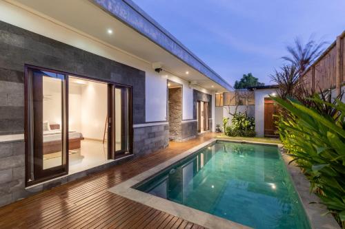 an indoor swimming pool in the backyard of a house at Villa Estella ☆ Seminyak Kuta - Private Pool in Seminyak