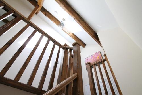 a staircase in a house with a vaulted ceiling at The Hoglets in Goostrey