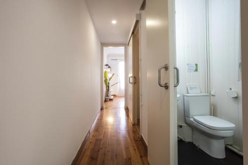 a bathroom with a toilet and a hallway at 21par1005 - Beautiful Apartment in Paral-lel in Barcelona