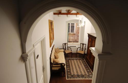 an archway leading to a hallway with chairs and a table at Celenga Apartments with free offsite parking in Dubrovnik