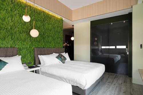 Postel nebo postele na pokoji v ubytování 森行旅 Mori Hotel -台南安平老街