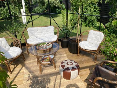 a patio with two chairs and a table with a football at Det blågrønne Hus in Hals
