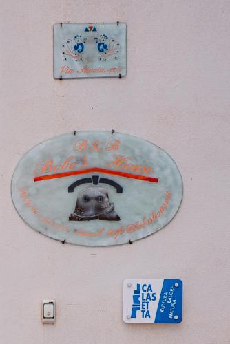 a sign on the side of a building with a picture at Bobo's House Calasetta in Calasetta
