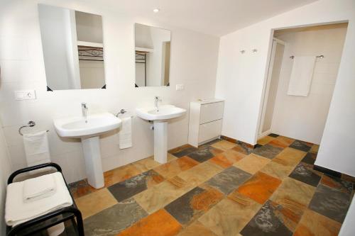 a bathroom with two sinks and two mirrors at Magnificient Rural Home With Pool and BBQ in Alicante