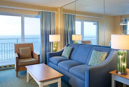 a living room with a blue couch in a hotel room at Fantasy Island II in Daytona Beach Shores