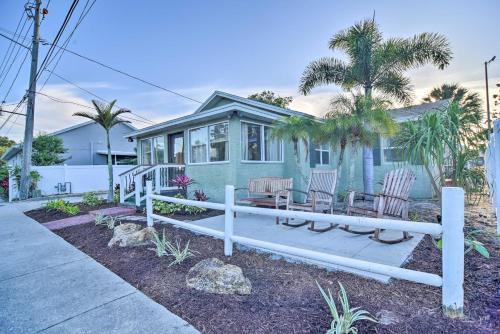 a house with a bench and chairs in front of it at Vibrant Dunedin Getaway with Furnished Patio! in Dunedin